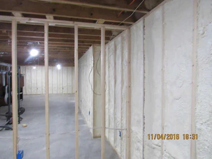Basement foundation walls sprayed with closed-cell foam insulation