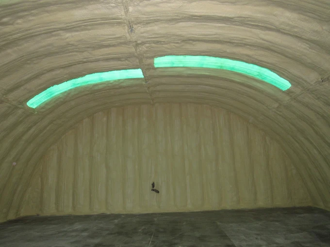 Arched quonset hut interior fully coated with spray foam insulation