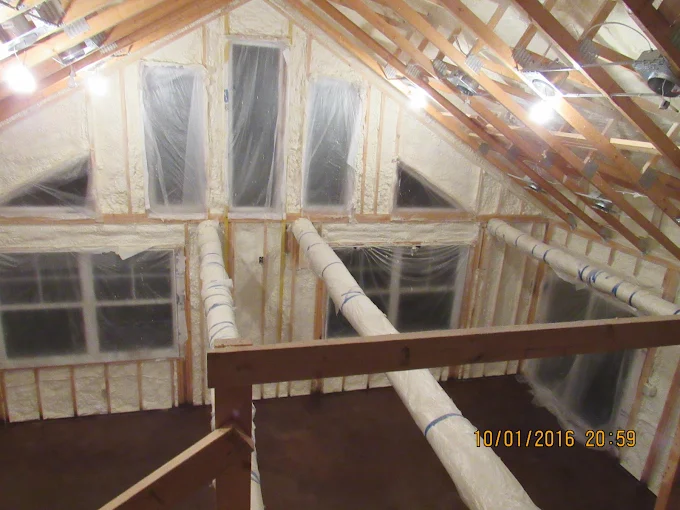 Vaulted attic roofline and knee walls insulated with spray foam