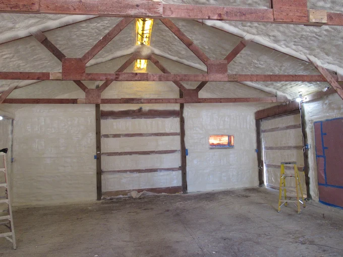 Pole building interior with walls and ceiling sealed in closed-cell spray foam